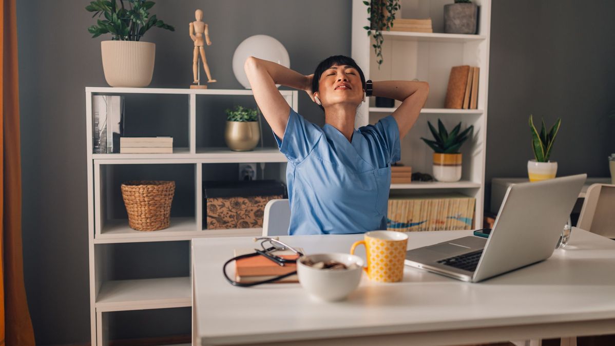 Workspace setup showing a person pausing for a seated desk refresh exercise